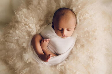 Newborn-baby-sleeping-on-his-back-by-Lifetime-Stories-Photography
