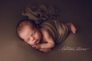 newborn photography by Lifetime Stories Photography on the dog bed